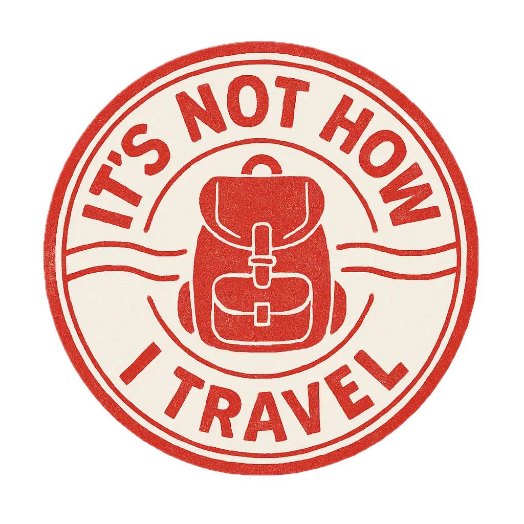 A circular stamp design featuring a red backpack illustration in the center with the text 'IT'S NOT HOW I TRAVEL' encircling it.
